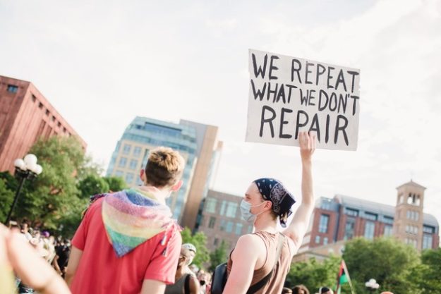 woman-holding-a-sign-at-a-protest-4613901